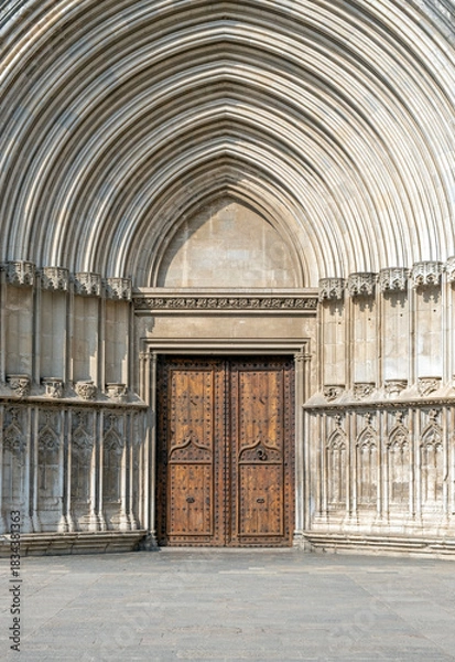 Fototapeta Decorative entrance door to a Gothic church, ancient cathedral gate