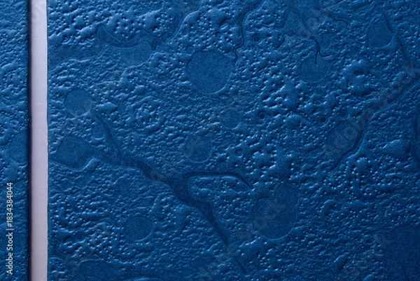Obraz Blue embossed texture background with a white vertical strip for text. Close-up of a metallic gift box surface perfect for men’s greeting cards. Photo
