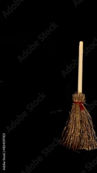Obraz Mini witch brooms on black background, occult props, mystical composition, esoteric tools for magic and rituals