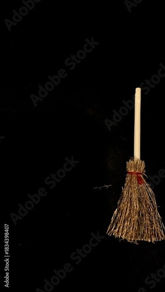 Obraz Mini witch brooms on black background, occult props, mystical composition, esoteric tools for magic and rituals
