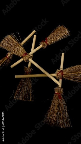 Obraz Mini witch brooms on black background, occult props, mystical composition, esoteric tools for magic and rituals