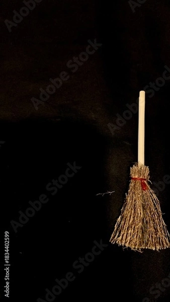 Obraz Mini witch brooms on black background, occult props, mystical composition, esoteric tools for magic and rituals