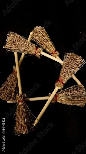 Obraz Mini witch brooms on black background, occult props, mystical composition, esoteric tools for magic and rituals