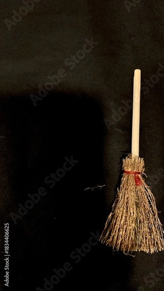 Obraz Mini witch brooms on black background, occult props, mystical composition, esoteric tools for magic and rituals