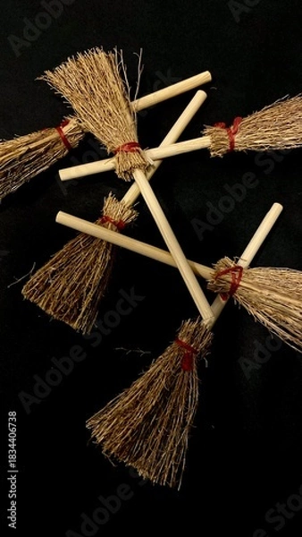 Obraz Mini witch brooms on black background, occult props, mystical composition, esoteric tools for magic and rituals