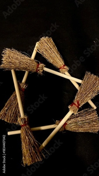 Obraz Mini witch brooms on black background, occult props, mystical composition, esoteric tools for magic and rituals