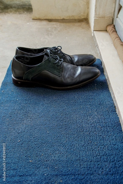 Obraz men's shoes at the front door, apartment door