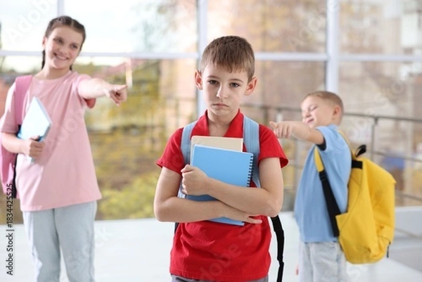 Obraz Boy getting bullied by his classmates in school, selective focus