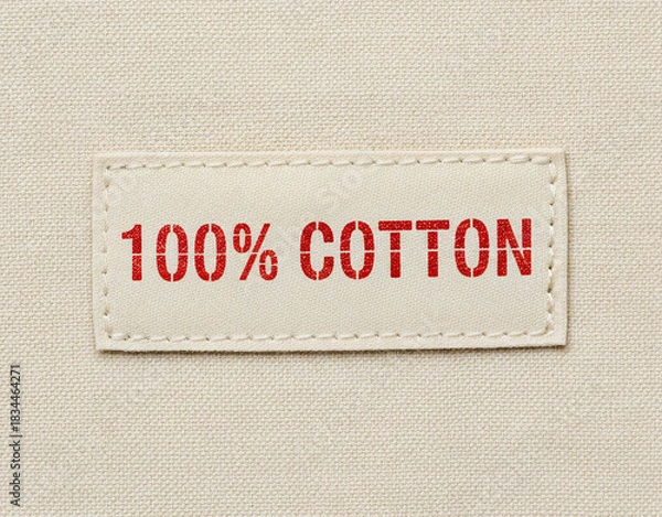 Fototapeta 100 Cotton Fabric Label with Red Text on Textile Background