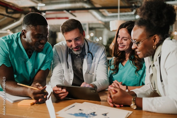 Fototapeta Medical team collaborating and discussing health data using tablet