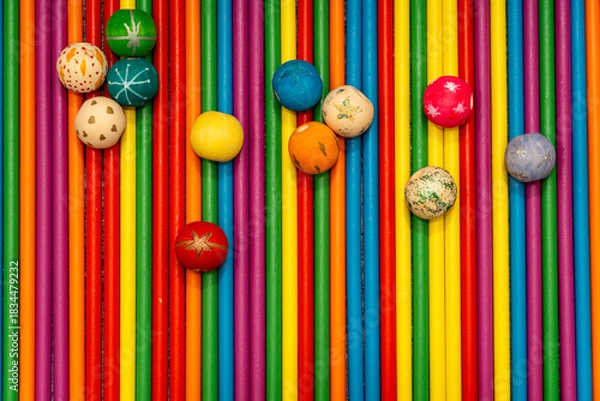 Fototapeta Top view of arranged colorful wooden sticks and painted beads. Abstract rainbow background for crafts or kids