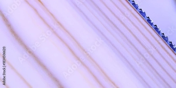 Fototapeta Close-up shot of a wooden surface with visible grain and a saw edge.