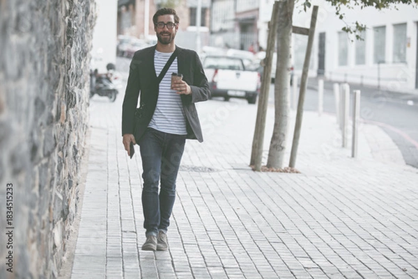 Fototapeta Walking, portrait and man with coffee in city for travel, morning commute and journey to work. Professional, happy and person with drink in urban town for career, business and trip to destination