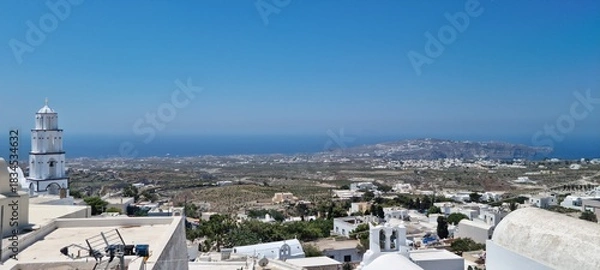 Obraz View of the coast and buildings from a high point in Santorini, Greece during a sunny day with clear blue sky