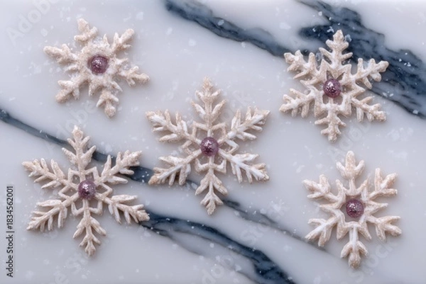Fototapeta Decorative snowflake cookies with glitter center on a white marble background. Elegant winter holiday dessert for Christmas and New Year.