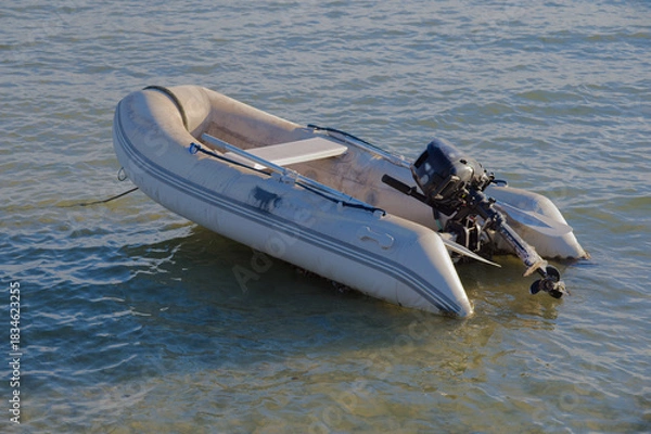 Obraz Small White Boat Floating on Calm Water, Seaside Scene with Gentle Waves in Gulfport, FL.
Sea water, reflecting soft light. The scene conveys solitude and peacefulness, ideal for travel, coastal lifes