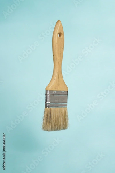 Fototapeta The brush is placed neatly on a bright blue background, creating a clean and modern look