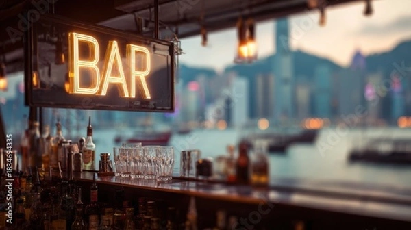 Obraz Neon bar sign lights up a lively waterfront scene in Hong Kong during sunset