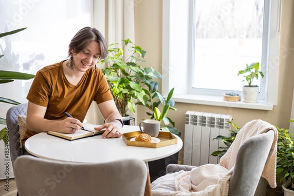 Obraz Stylish confident guy writing in journal