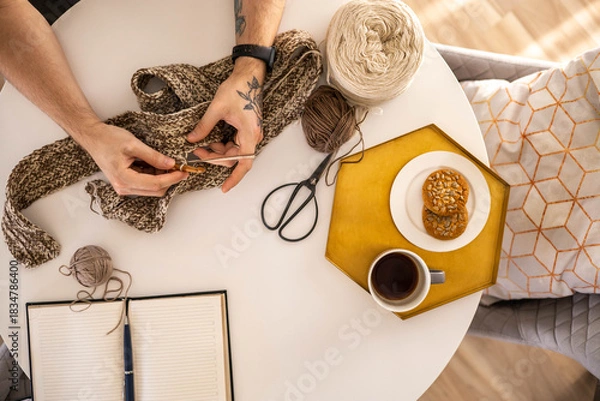 Obraz Feminine male hands crochet handmade artwork hobby wooden table with sewing tools closeup top view