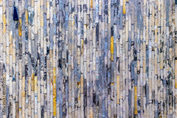 Fototapeta Colorful stone wall with vertical patterns and textures