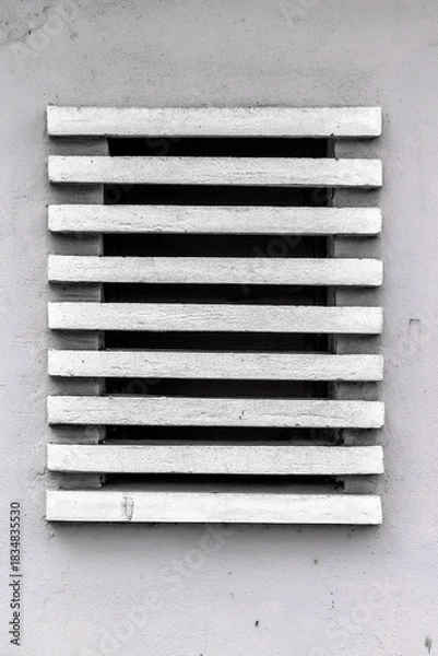 Fototapeta White ventilation grate on gray wall with horizontal slats