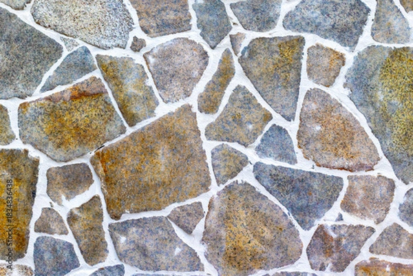 Fototapeta Irregular stone wall with grout in various shades and textures