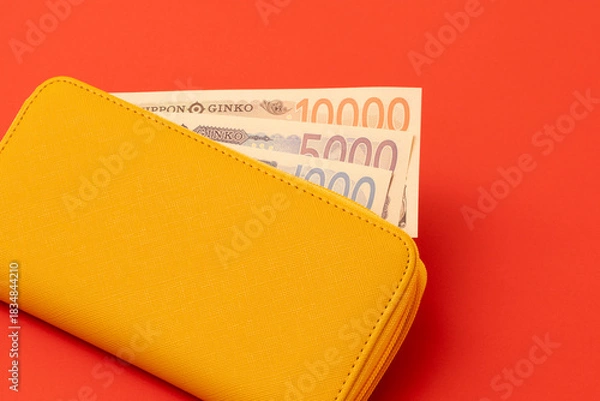 Obraz Yellow wallet and Japanese banknotes. Household finances, savings, good fortune, financial luck, deposits, property, expenses, budgets, etc.  黄色の財布と日本紙幣（お金）。家計、預金、幸運、金運、貯金、財産、出費、予算など