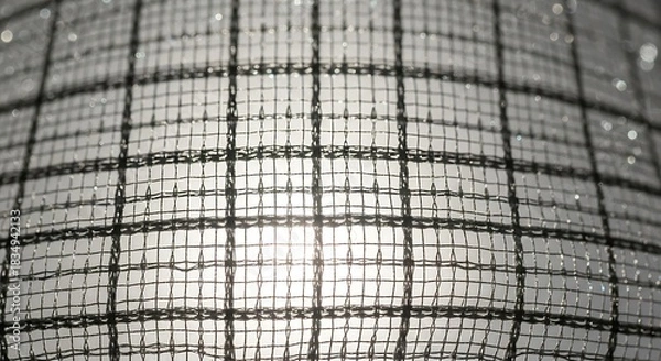Fototapeta Translucent checkered fabric texture with bright light shining through.