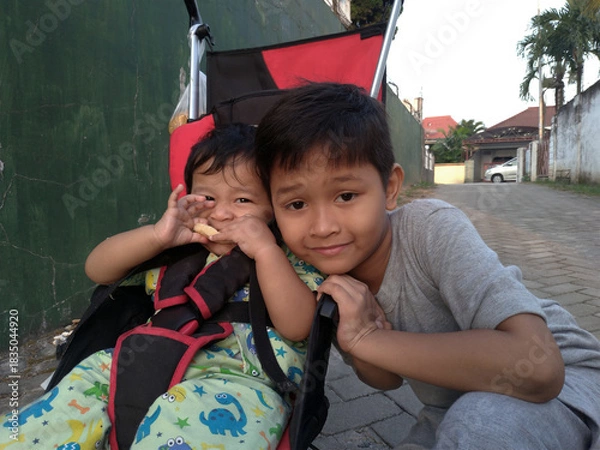 Obraz Caring Sibling with Baby in Stroller