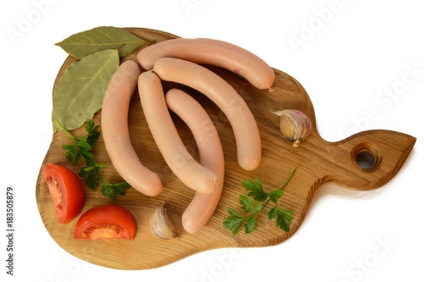Fototapeta Raw fresh sausage with tomatoes and parsley on wooden desk isolated on white