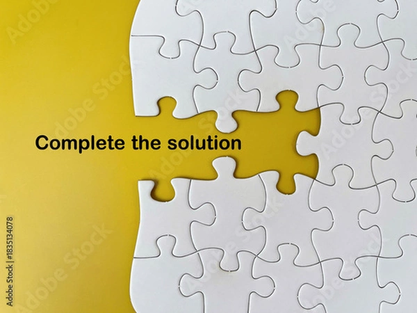 Obraz Missing puzzle piece concept with text ‘Complete the solution’ on yellow background representing problem solving and strategic connection.