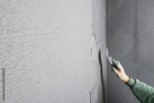 Fototapeta Applying concrete pebble plaster kornik using putty knife.