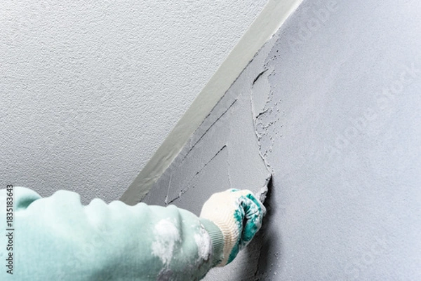 Fototapeta Applying concrete pebble plaster kornik using putty knife.