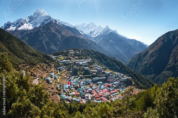 Fototapeta Panoramic View of iconic high-altitude Namche Bazaar. Unique amphitheater-shaped settlement nestled amidst majestic, snow-capped Himalayan peaks in Khumbu region of Nepal.