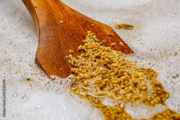 Obraz Close up of wooden shovel with wheat grains inside of a modern kettles, vessels, in a beer plant in Quito