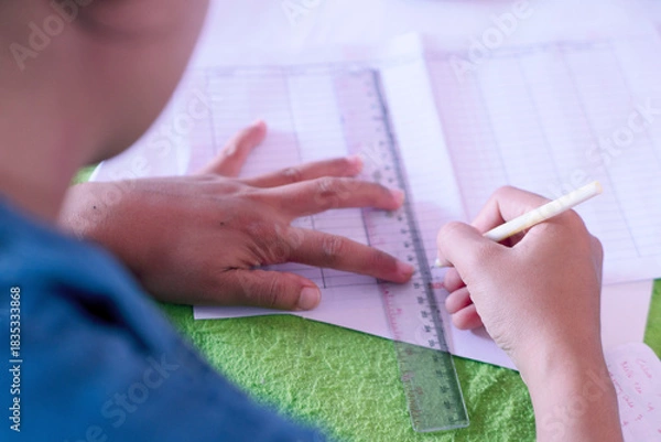 Obraz Close Up Person Writing Study Notes wile using ruler and pen