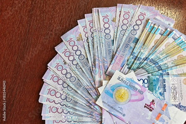 Fototapeta Counting cash on the table, next to the car keys, in the office during the day. Buying a new car.