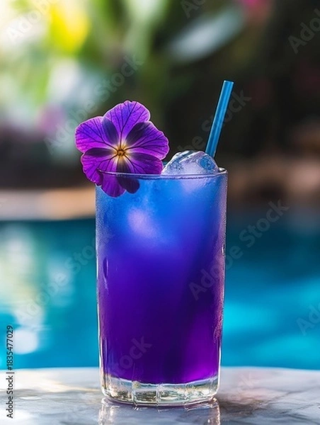 Obraz A refreshing drink in a glass with ice and a lavender flower for garnish.