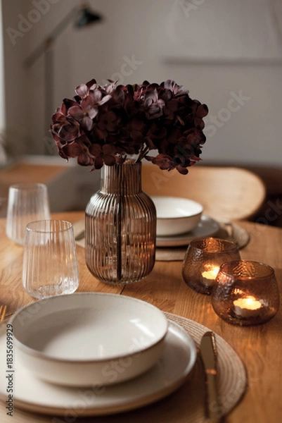 Obraz Wooden round table setting with glassware and vase creating a stylish evening atmosphere