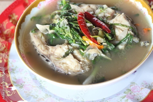Obraz Boiled tilapia in a bowl on wooden table