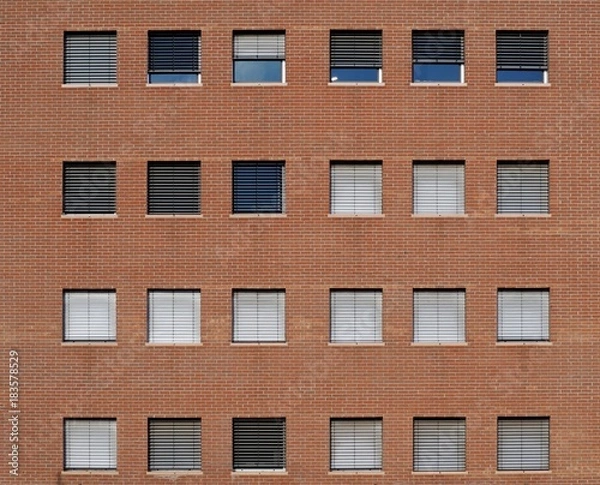 Fototapeta Brick wall facade of a modern building with square windows