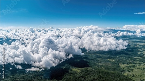 Fototapeta Clouds Floating Above Lush Green Landscape Under Blue Sky
