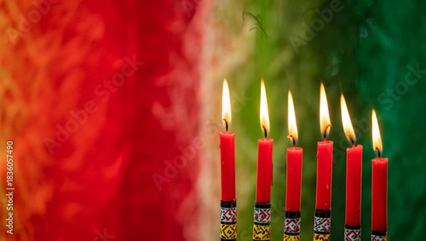 Fototapeta Seven red candles burning brightly on a kwanzaa kinara with a colorful background
