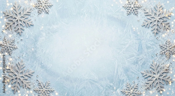 Fototapeta Clean winter New Year frame with icy blue background, silver snowflakes around corners empty center space for text