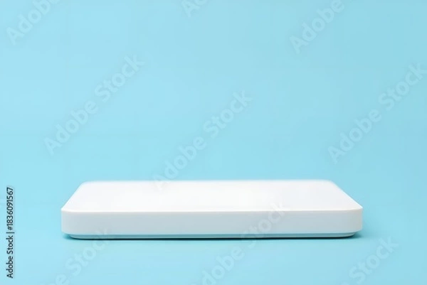 Fototapeta White box on light blue background showcases minimalism and simplicity nicely here