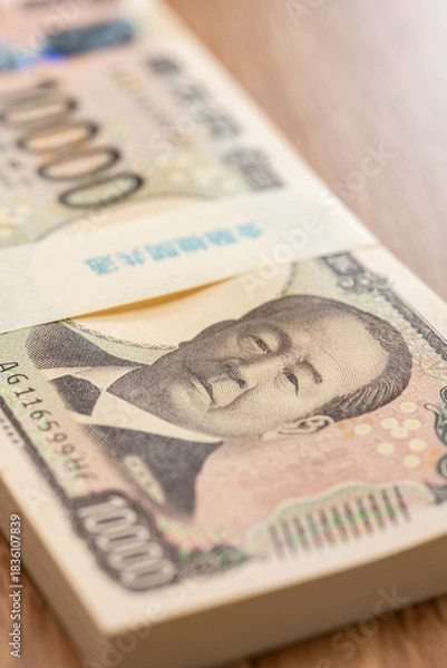 Obraz 日本円一万円札が束ねられた百万円帯による資産と金融イメージ