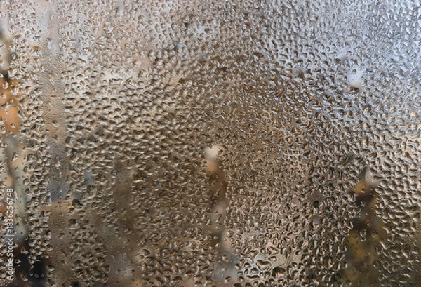 Fototapeta Water droplets clearly visible on a window surface. window with condensation visible as moisture droplets. the surface of the wet glass. Abstract background for creatives.