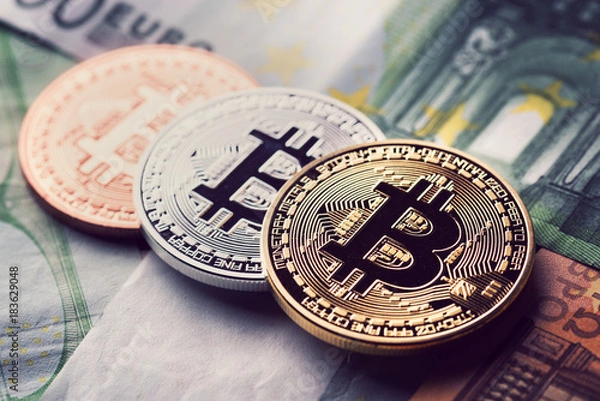 Obraz Bitcoins on banknotes