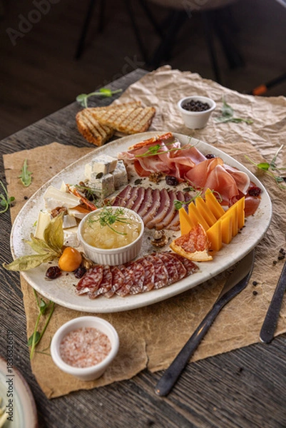 Fototapeta Deluxe charcuterie board showcasing gourmet meats